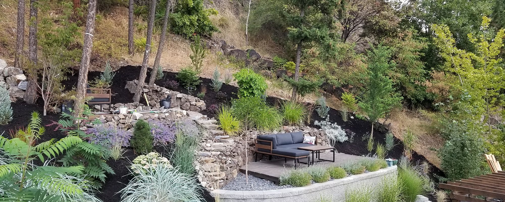 Outdoor living space layered up the Mountain, sitting area in the natural woodland.